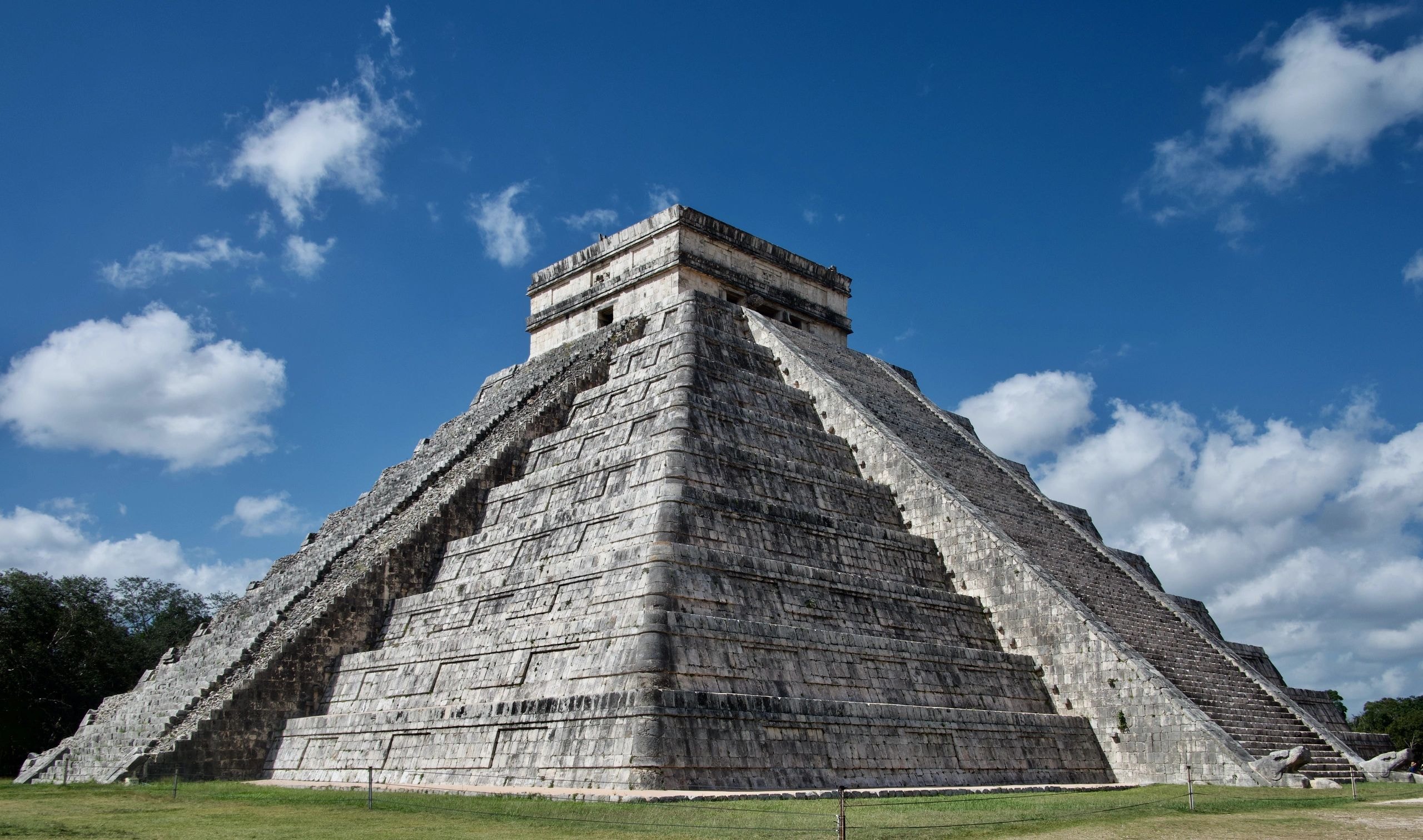Ancient Mayan pyramid against a clear blue sky